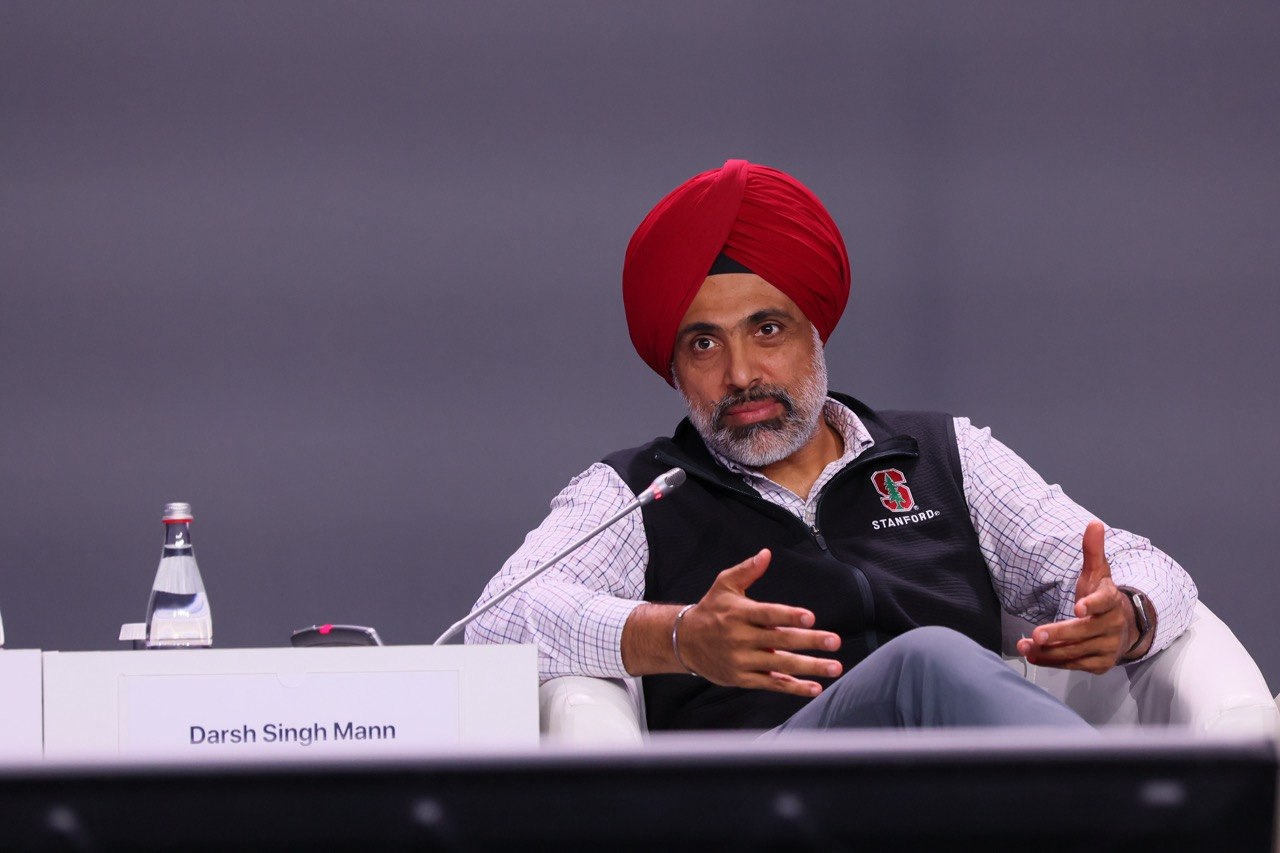 Darsh gesturing as he answers a question on stage